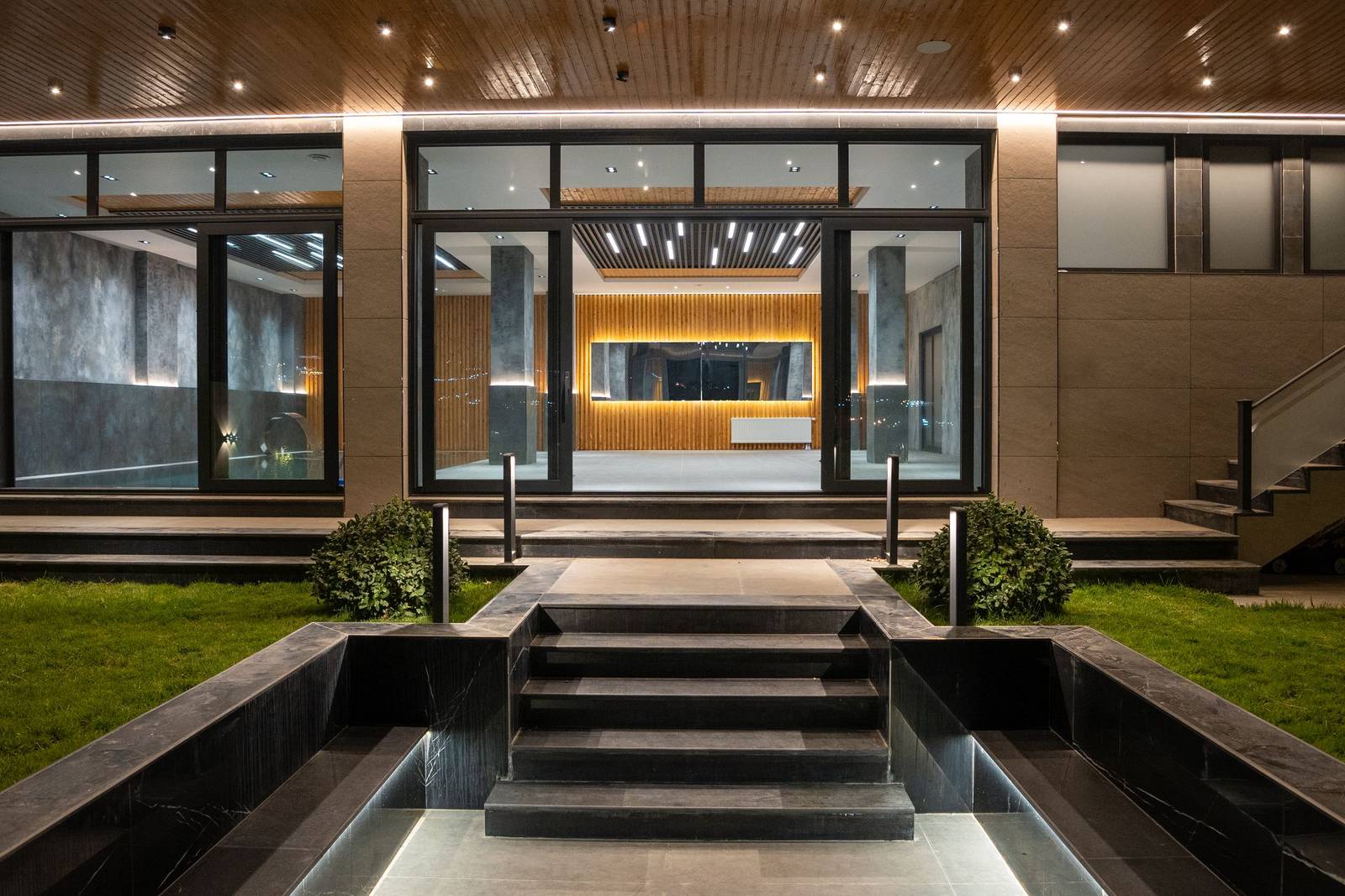 Modern home entrance lit at night