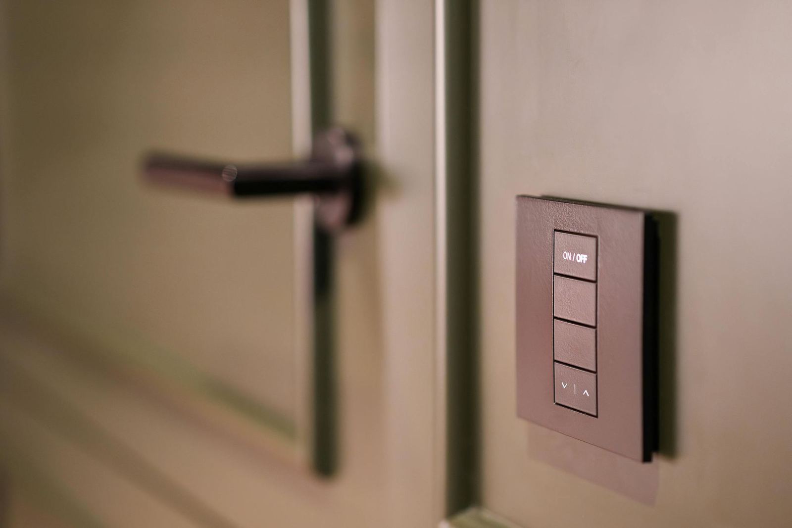 Lighting control keypad mounted beside a doorway